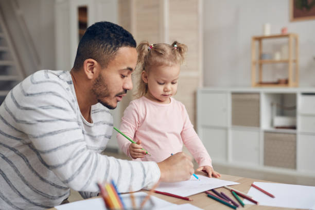istock Cute Girl Drawing with Dad 1191693086