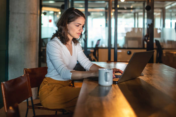 istock Young Businesswoman Concentrating While Typing on Laptop 1191693447