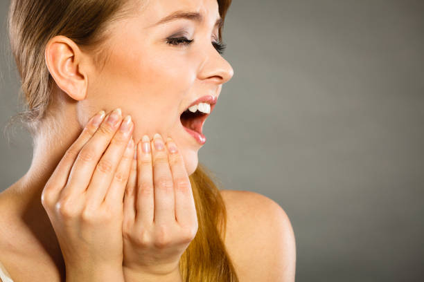 istock Woman suffering from tooth pain 1191695387