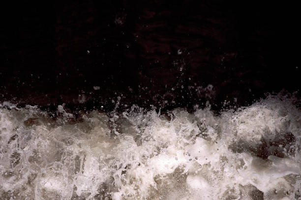 istock Water splash in black and white. Darkness ans shadow. Water in dynamic motion. Monochrome abstract background. Dark and light, foam and bubbles, water in motion close up. Spraying water. 1191696254