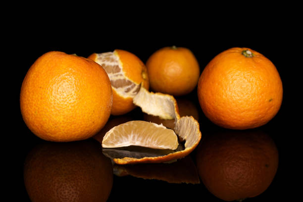 istock Fresh orange mandarin isolated on black glass 1191696439