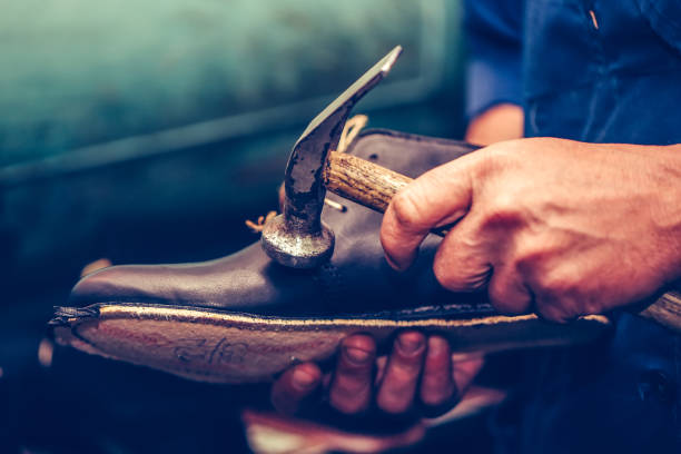 istock Shoemaker making comfortable hand made shoes for people 1191696515