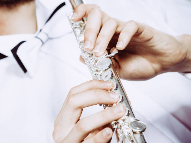 istock Hands of young man playing the flute 1191699029