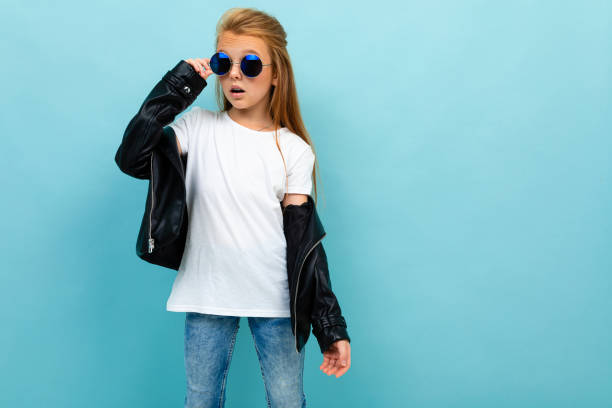 istock cool cheerful schoolgirl posing on blue wall background 1191699738