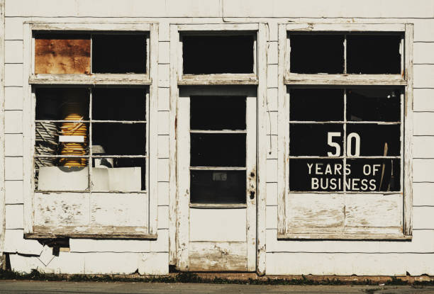 A neighbourhood convenience store is boarded up following bankruptcy.  The facility appears to be abandoned.