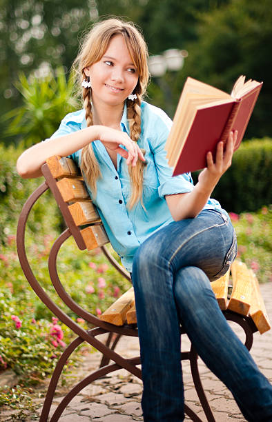 istock beautiful young student girl reading book 119170146