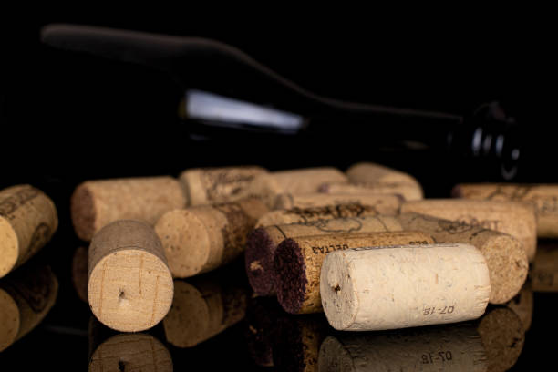 istock Common wine cork isolated on black glass 1191704577