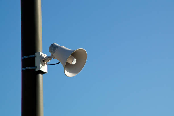 istock Loud speaker on pole against blue sky 1191705791