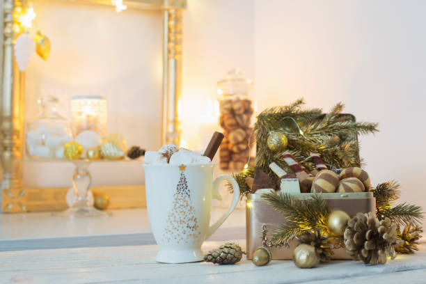 istock Christmas sweets in golden box and cocoa mug with marshmallows o 1191707206