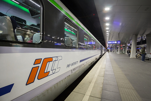 Picture of a passenger car on a train belonging to PKP intercity ready for departure on a platform of Wien Hbf train station for a Eurocity service towards Poland. PKP Intercity is a company of PKP Group responsible for long-distance passenger transport. It runs about 350 trains daily, connecting mainly large agglomerations and smaller towns in Poland. The company also provides most international trains to and from Poland.