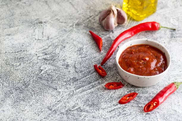 istock ketchup with hot chili pepper and garlic on a gray concrete background with copy space 1191707607