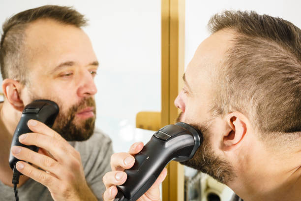 istock Man shaving trimming his beard 1191710223