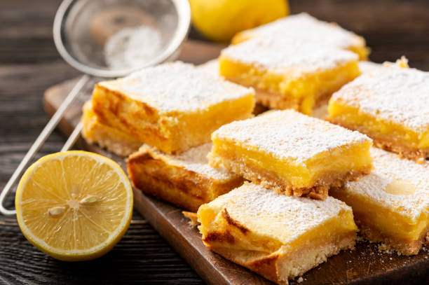 istock Homemade lemon bars with shortbread crust, on wooden background. 1191714220