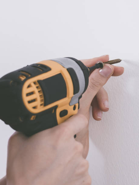 istock Person drilling in wall 1191715303