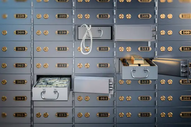 Photo of Open safe deposit box with money, jewels and golden ingots. Financial banking investment concept.