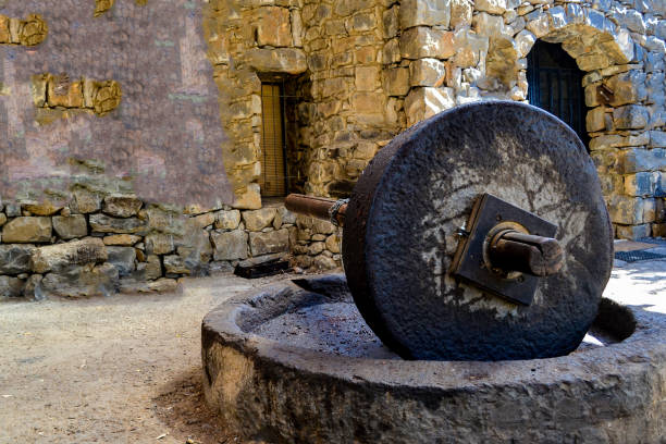 istock Old stones for squeezing olives oil, stone mill and mechanical press. 1191720144