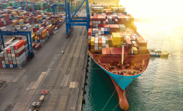 istock Container ship in export and import business logistics and transportation. Cargo and container box shipping to harbor by crane. Water transport International. Aerial view and top view. 1191721335