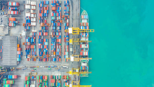 istock Container ship in export and import business logistics and transportation. Cargo and container box shipping to harbor by crane. Water transport International. Aerial view and top view. 1191721346