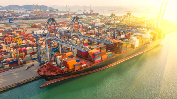 istock Container ship in export and import business logistics and transportation. Cargo and container box shipping to harbor by crane. Water transport International. Aerial view and top view. 1191721353
