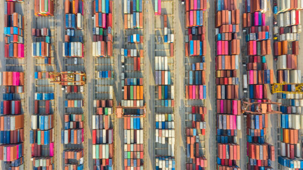 istock Container ship in export and import business logistics and transportation. Cargo and container box shipping to harbor by crane. Water transport International. Aerial view and top view. 1191721381