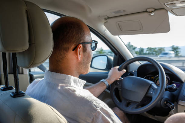 istock Man with sunglasses driving car 1191721482