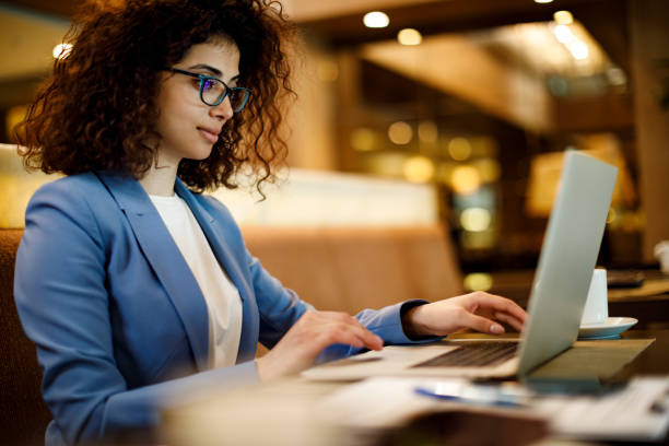 istock Businesswoman working on laptop at a cafe 1191722811