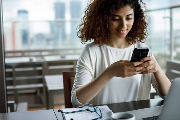 Smiling young woman using mobile phone