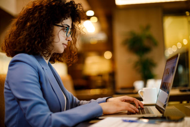 istock Businesswoman working on laptop in restaurant 1191722816