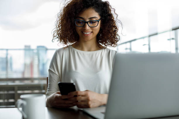 istock Smiling young woman using mobile phone 1191722870