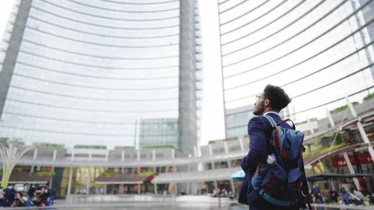 Young intern looking at his new office building