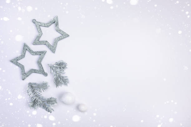 istock Flat lay composition with Christmas decor with silver stars, silver spruce branches. Minimalism, a copy space 1191723090