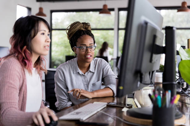 istock Focused businesswomen working together 1191725540