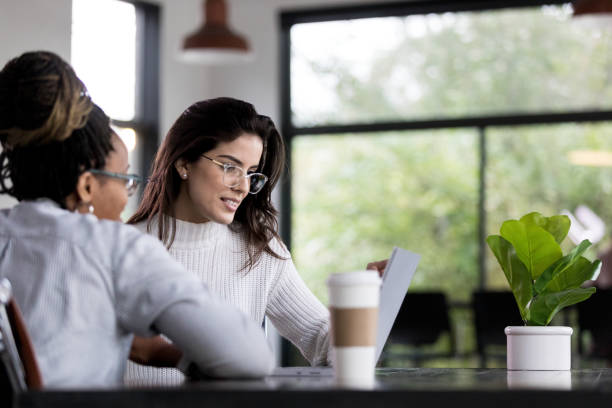 istock Businesswomen working on project together 1191725550