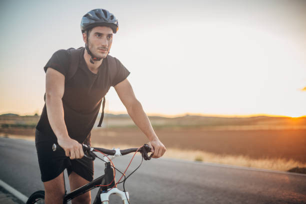istock Handsome young man riding a bike 1191725932