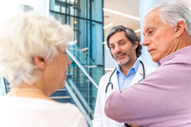 istock Doctor talks with a senior couple 1191726097