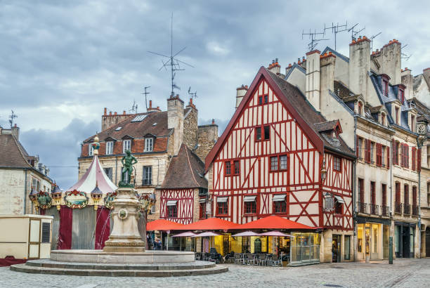 Francois Rude square, Dijon, France Francois Rude square with fountain of a Bareuzai wine-grower in Dijon, France dijon stock pictures, royalty-free photos & images