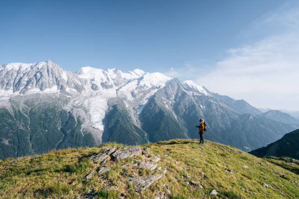 istock Female hiker relaxing on mountain ridge uses digital tablet 1191728937
