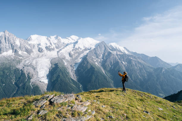 istock Female hiker relaxing on mountain ridge uses digital tablet 1191729156