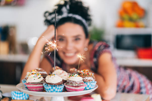 istock Confectioner holding birthday cupcakes 1191729882