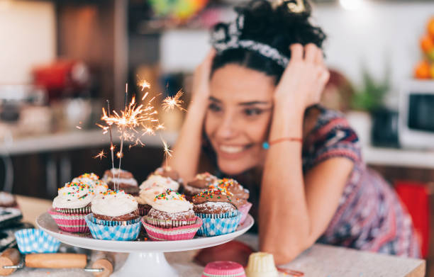 istock Confectioner holding birthday cupcakes 1191729890