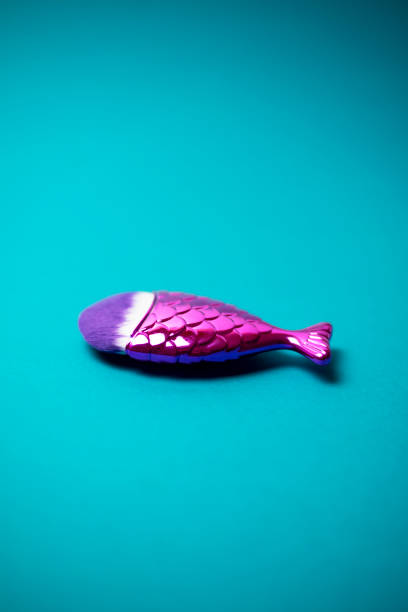 istock Mermaid tail makeup brush on a turquoise background. 1191730010