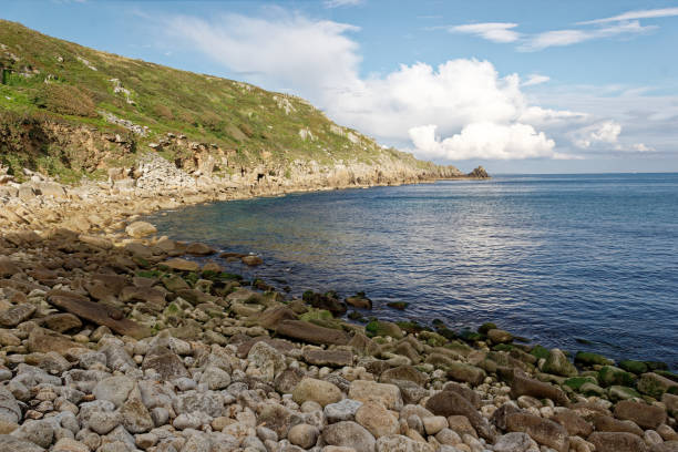 Lamorna Cove Cornwall looking out to sea. Lamorna Cove West Cornwall. View across bay to headland. Blue sky and light cloud. Four miles south of Penzance. lamorna cove stock pictures, royalty-free photos & images