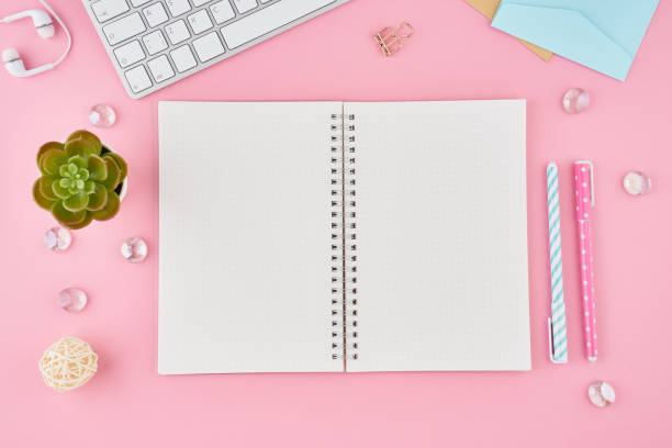 istock Blank notepad page in bullet journal on bright pink office desktop. Top view of modern bright table with notebook, stationery. Mock up, copy space, concept for diary 1191730538