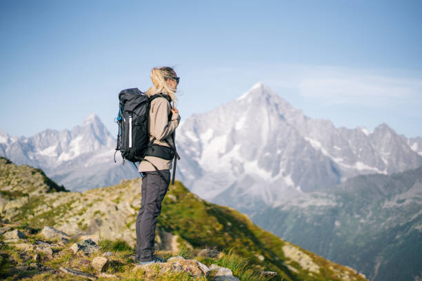 istock Female hiker walks along footpath on mountain ridge 1191730679
