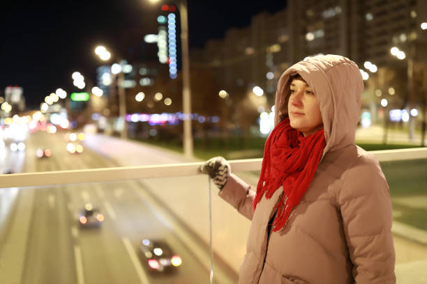 istock Woman on bridge at night 1191731509