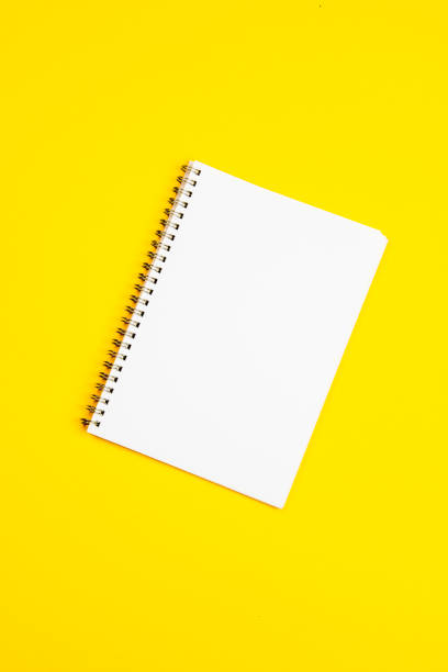 istock Empty white paper page on a yellow background 1191732391