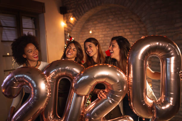 istock Girlfriends at New Year party holding balloons 2020 1191733882