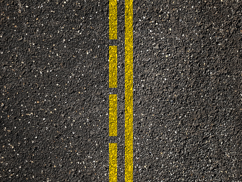 Asphalt road with dividing yellow lines