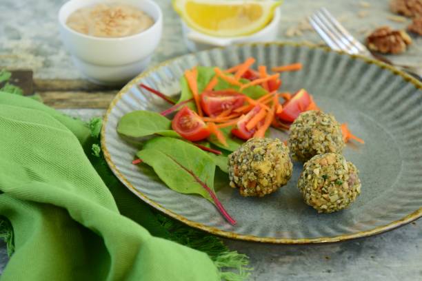 istock Seed falafel balls with vegetable salad and tahini dressing 1191734981
