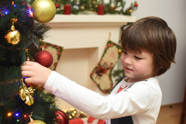 istock Portrait of happy boy decorating Christmas tree 1191735391